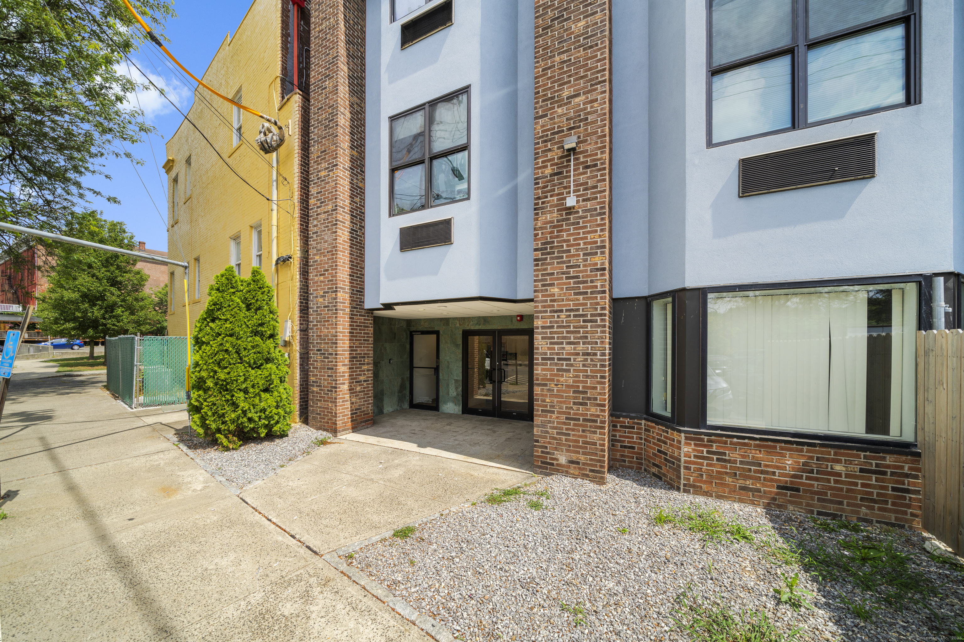 158 Main Street Ansonia, CT 06401 - Photo 25 of 26 a view of a brick house with plants