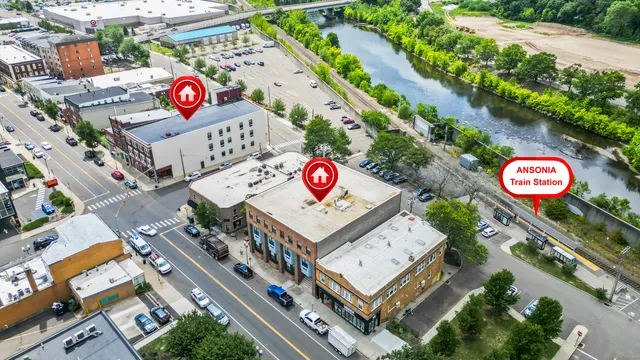 an aerial view of a multi story residential apartment building with a street