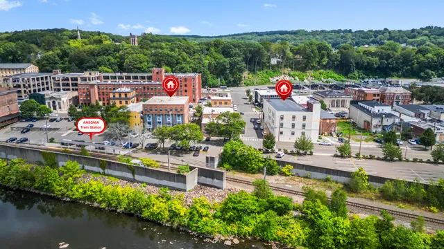 an aerial view of a house with a garden and lake view