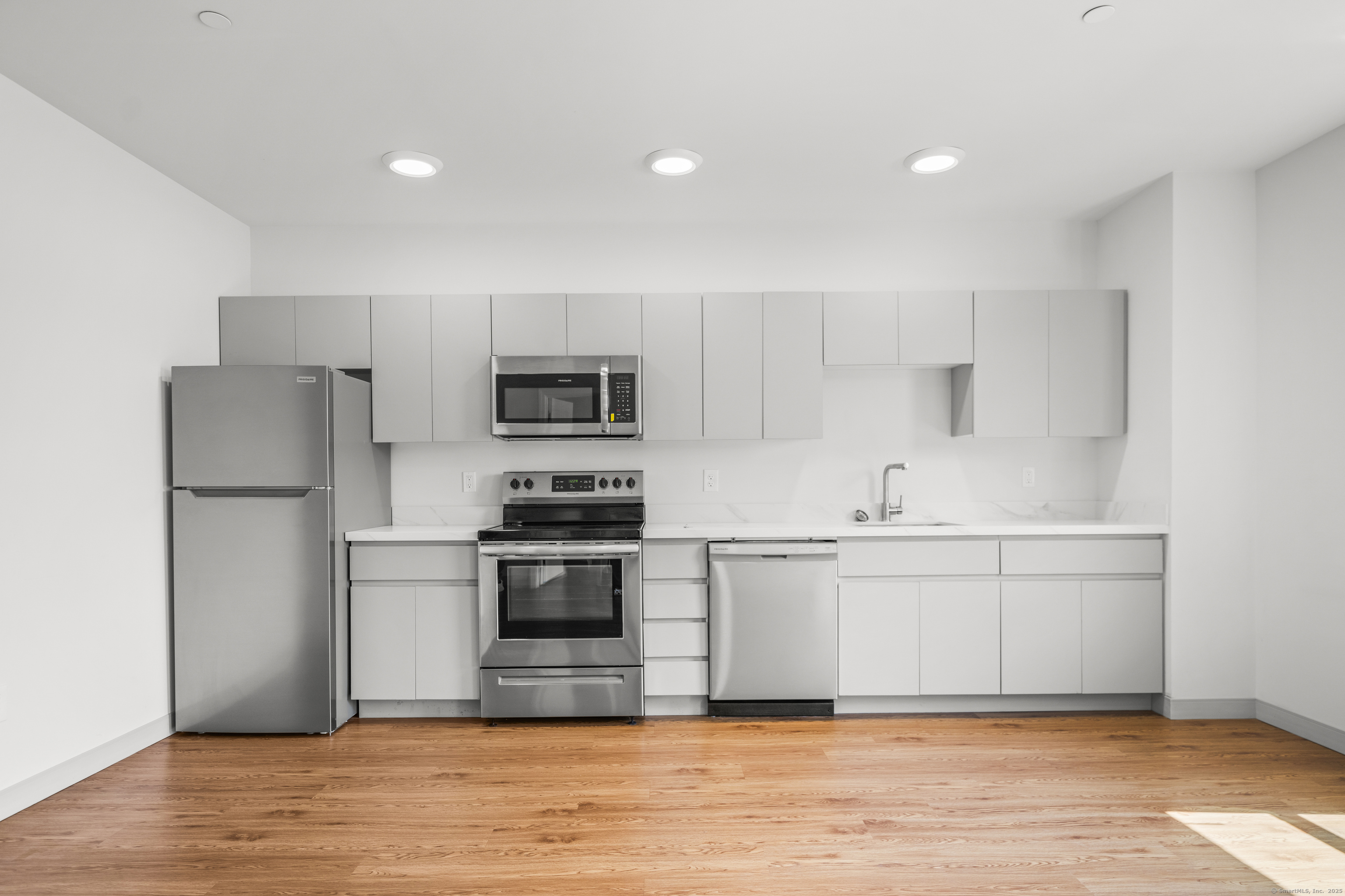 158 Main Street Ansonia, CT 06401 - Photo 6 of 26 a kitchen with stainless steel appliances a refrigerator stove microwave and sink