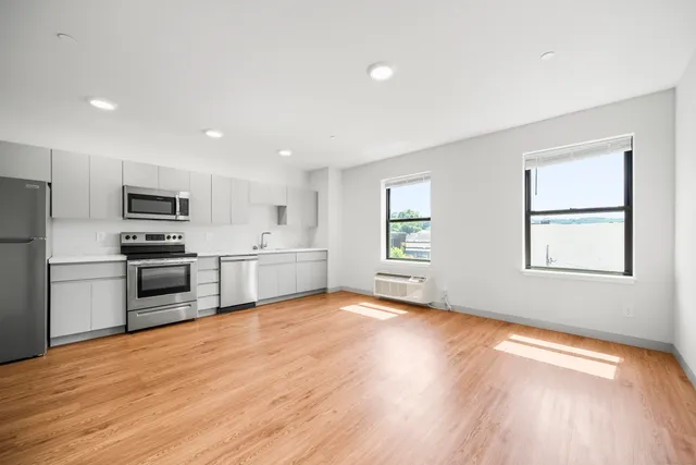 a kitchen with stainless steel appliances a refrigerator sink and microwave
