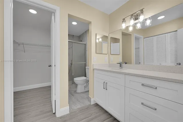 a bathroom with a toilet a sink and mirror