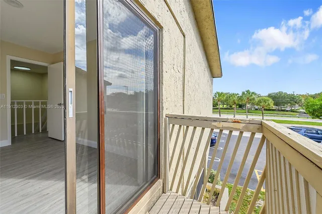 a view of balcony with wooden floor