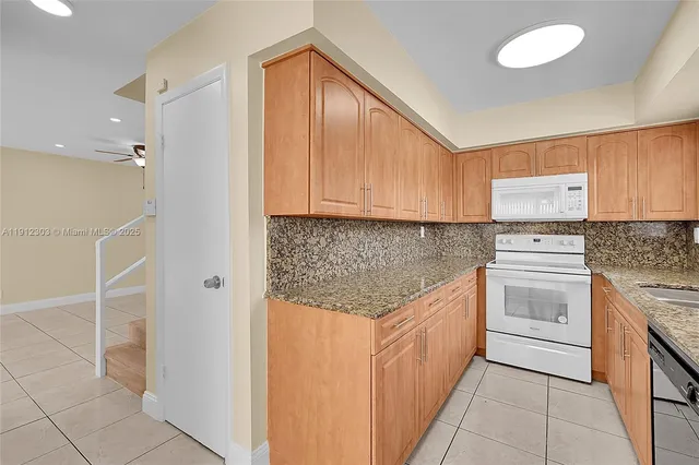 a kitchen with stainless steel appliances granite countertop a stove and a refrigerator