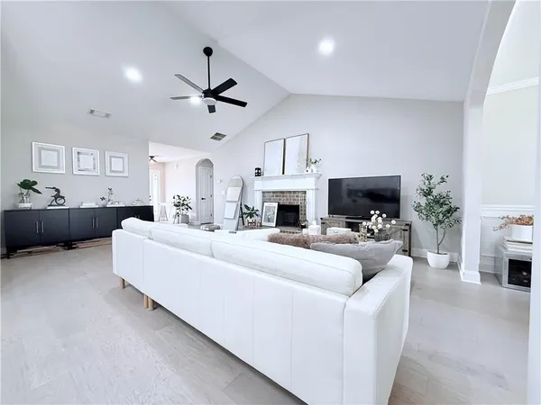 a living room with furniture a fireplace and a potted plant