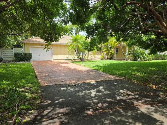 a view of a yard with a house and trees