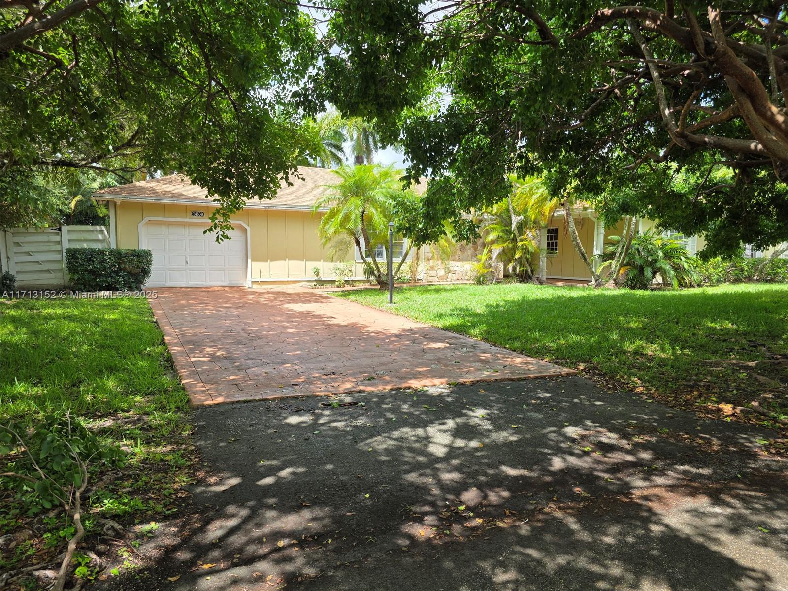 14630 Southwest 148th Court Miami, FL 33196 - Photo 2 of 15 a view of a yard with a house and trees