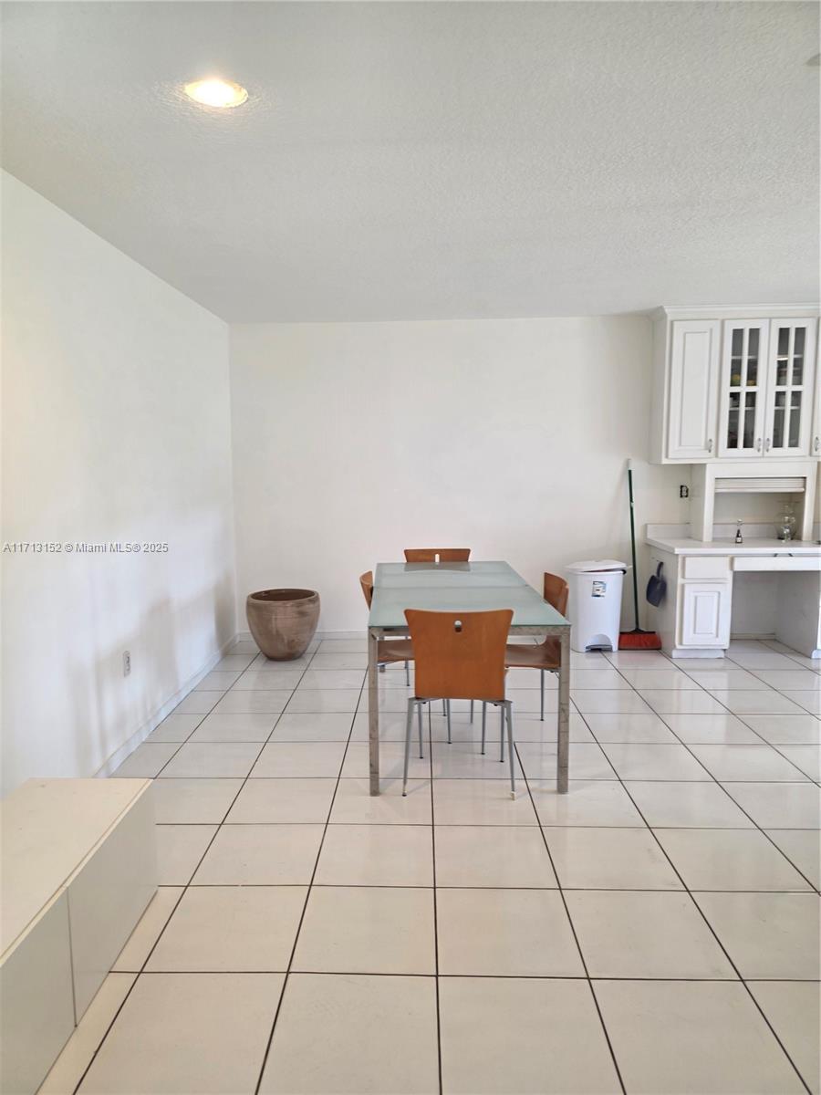 14630 Southwest 148th Court Miami, FL 33196 - Photo 7 of 15 a work room with furniture and a table