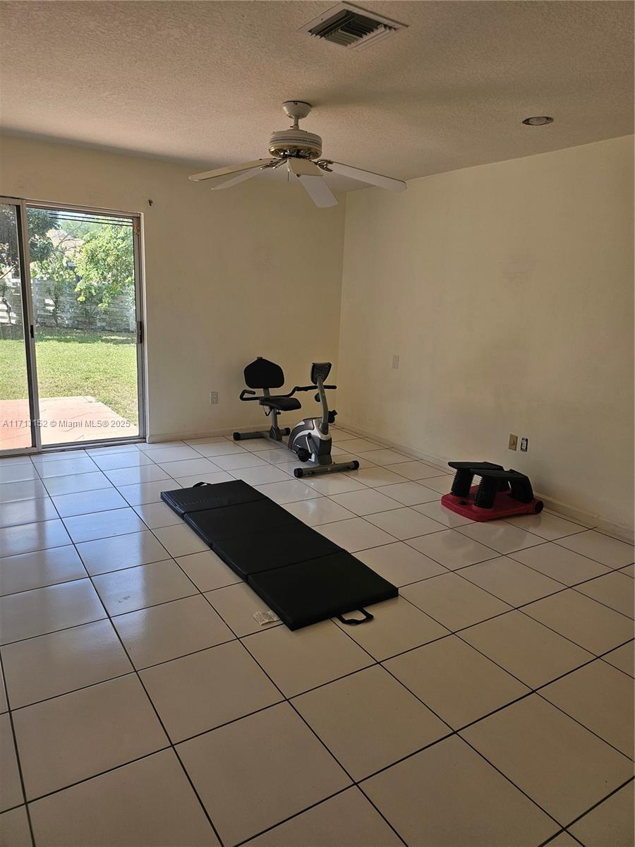 14630 Southwest 148th Court Miami, FL 33196 - Photo 8 of 15 a room with a table and a fireplace