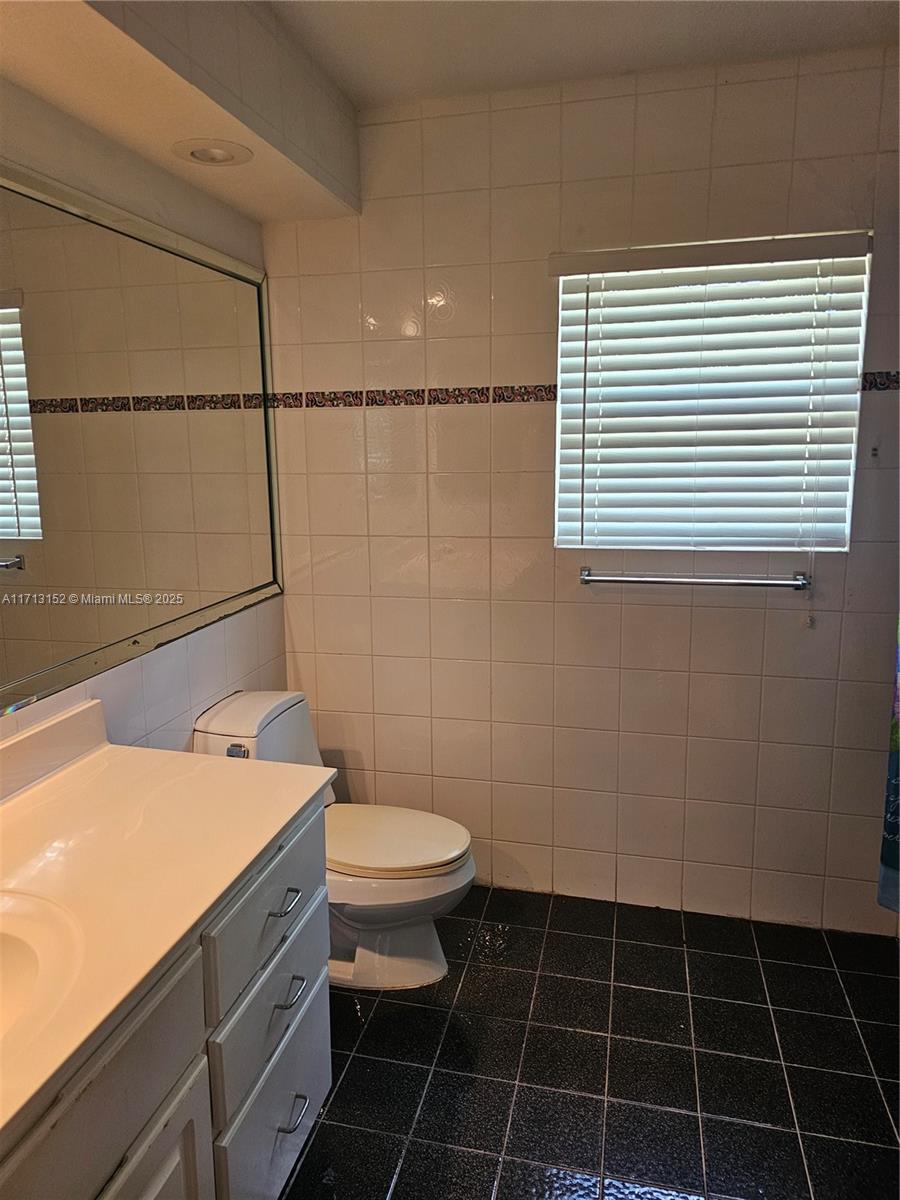 14630 Southwest 148th Court Miami, FL 33196 - Photo 10 of 15 a bathroom with a sink a toilet a mirror and shower