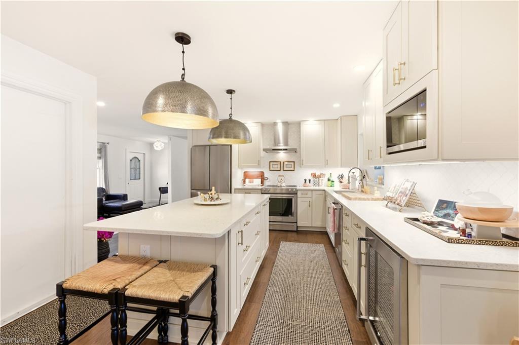 4630 11th Avenue Southwest Naples, FL 34116 - Photo 12 of 50 a kitchen with a stove a sink and a refrigerator