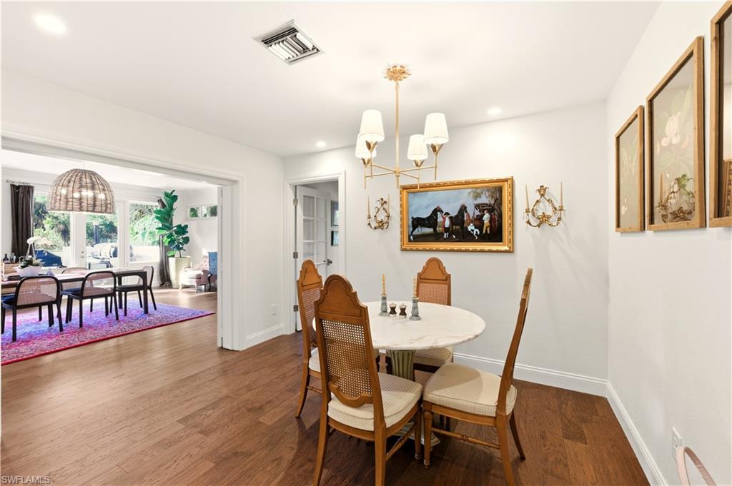 4630 11th Avenue Southwest Naples, FL 34116 - Photo 13 of 50 a view of a dining room with furniture window and wooden floor