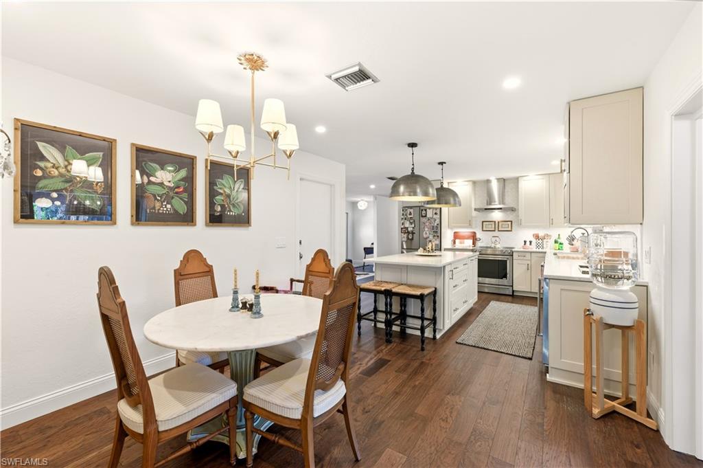 4630 11th Avenue Southwest Naples, FL 34116 - Photo 14 of 50 a view of a dining room with furniture and wooden floor