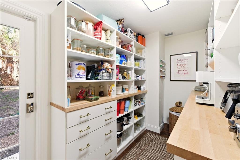 4630 11th Avenue Southwest Naples, FL 34116 - Photo 15 of 50 a view of walk in closet with clothes and shoes