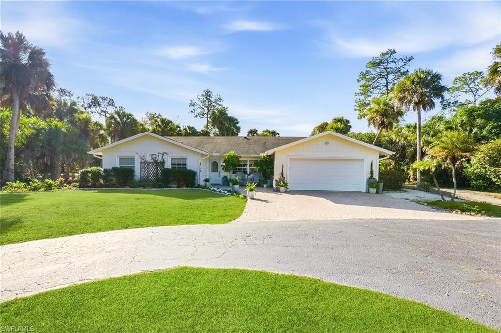4630 11th Avenue Southwest Naples, FL 34116 - Photo 2 of 50 a front view of house with yard and green space