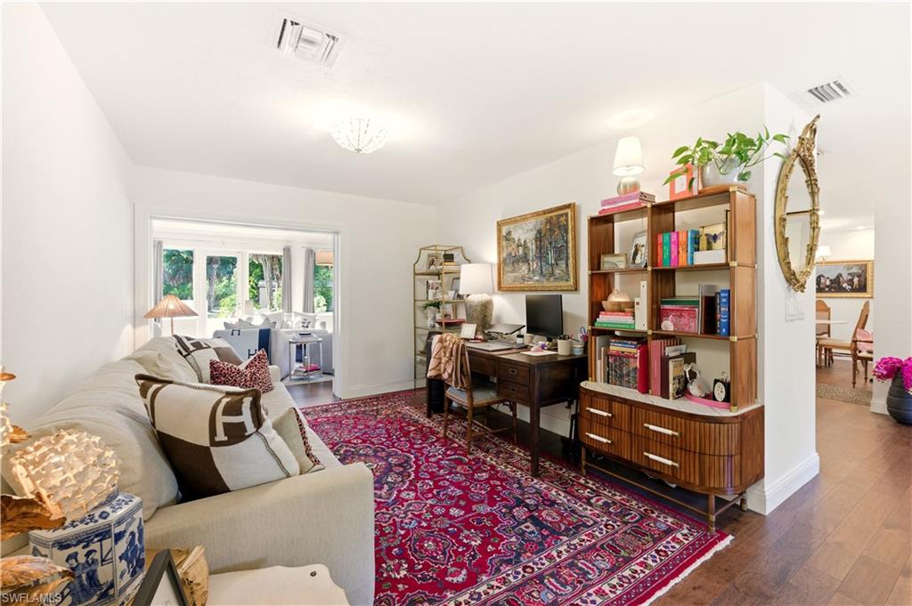 4630 11th Avenue Southwest Naples, FL 34116 - Photo 22 of 50 a living room with furniture and a book shelf