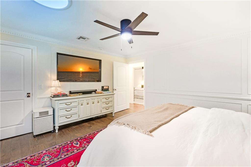 4630 11th Avenue Southwest Naples, FL 34116 - Photo 24 of 50 a spacious bedroom with a bed and a flat screen tv
