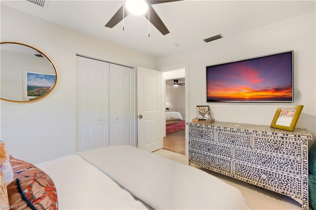4630 11th Avenue Southwest Naples, FL 34116 - Photo 29 of 50 a bedroom with a bed and a flat screen tv