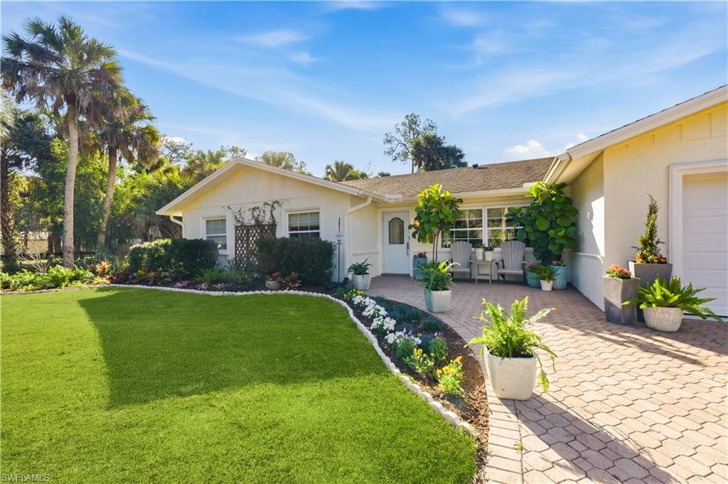 4630 11th Avenue Southwest Naples, FL 34116 - Photo 3 of 50 a front view of a house with garden