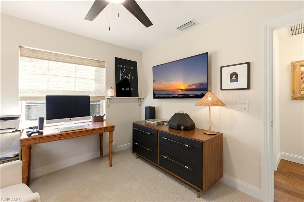 4630 11th Avenue Southwest Naples, FL 34116 - Photo 32 of 50 a work room with furniture and a flat screen tv