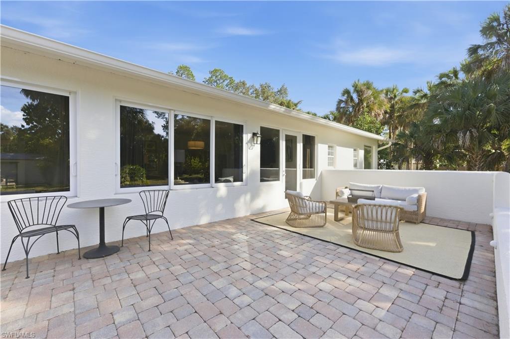 4630 11th Avenue Southwest Naples, FL 34116 - Photo 38 of 50 a view of a patio with a chairs and table in a patio