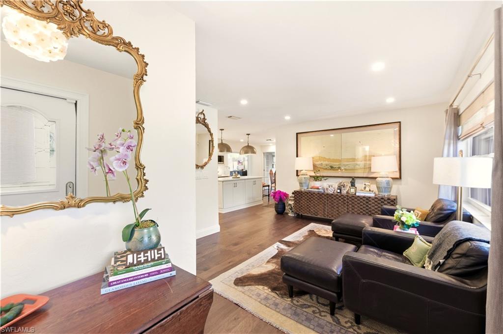 4630 11th Avenue Southwest Naples, FL 34116 - Photo 4 of 50 a living room with furniture and a wooden floor