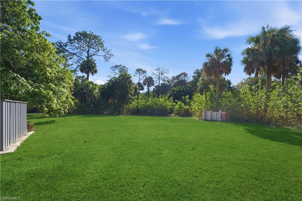 4630 11th Avenue Southwest Naples, FL 34116 - Photo 41 of 50 a view of a yard with a tree