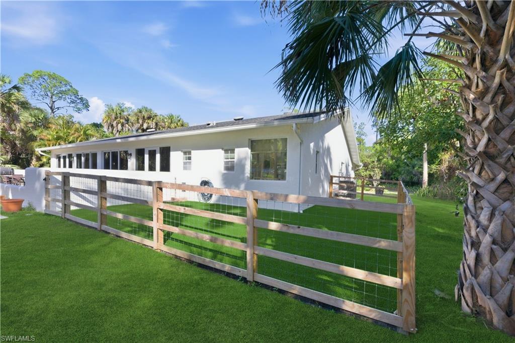 4630 11th Avenue Southwest Naples, FL 34116 - Photo 43 of 50 a view of backyard with deck and a garden