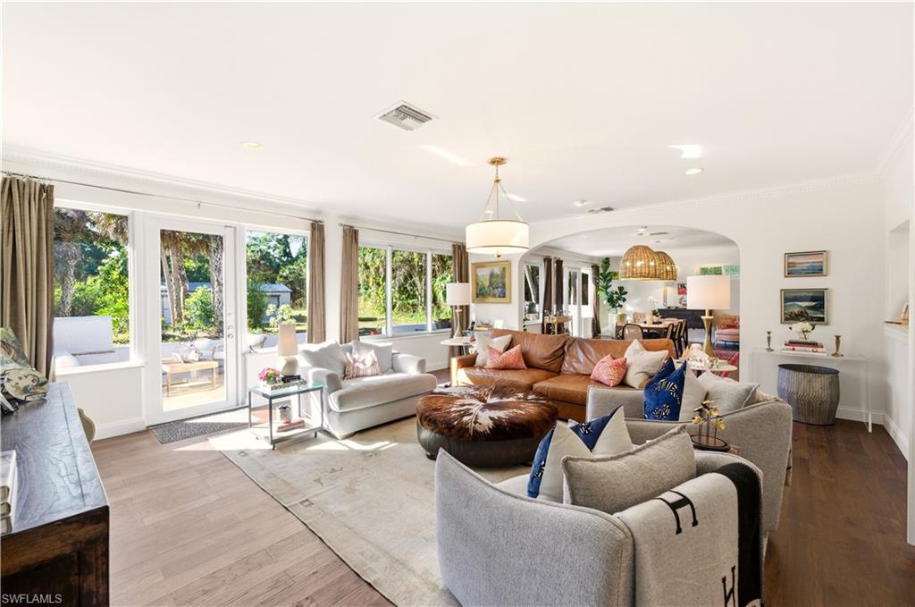 4630 11th Avenue Southwest Naples, FL 34116 - Photo 6 of 50 a living room with furniture and large windows
