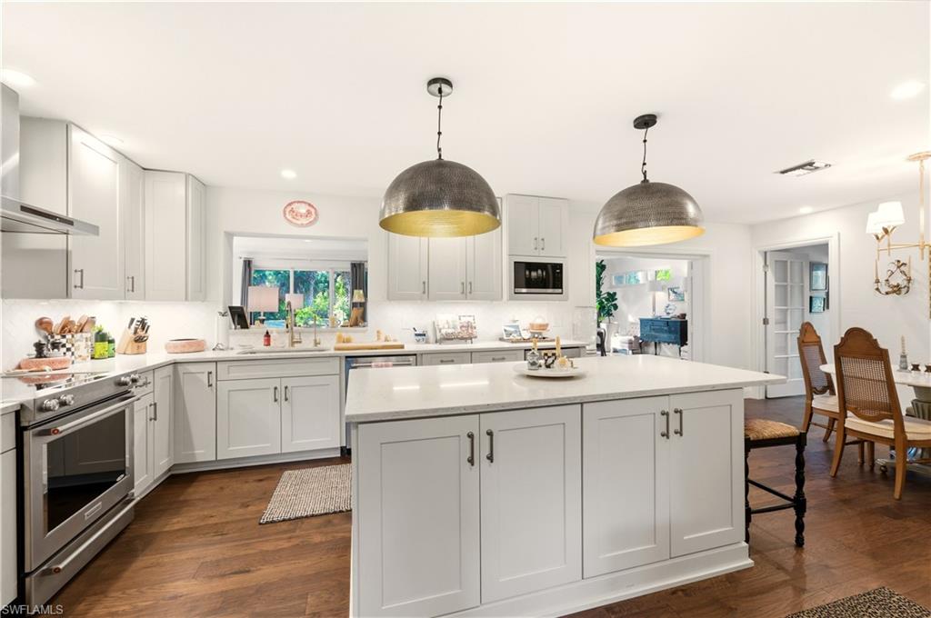 4630 11th Avenue Southwest Naples, FL 34116 - Photo 10 of 50 a kitchen with white cabinets and sink