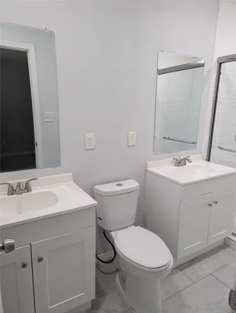 a bathroom with a sink toilet and mirror