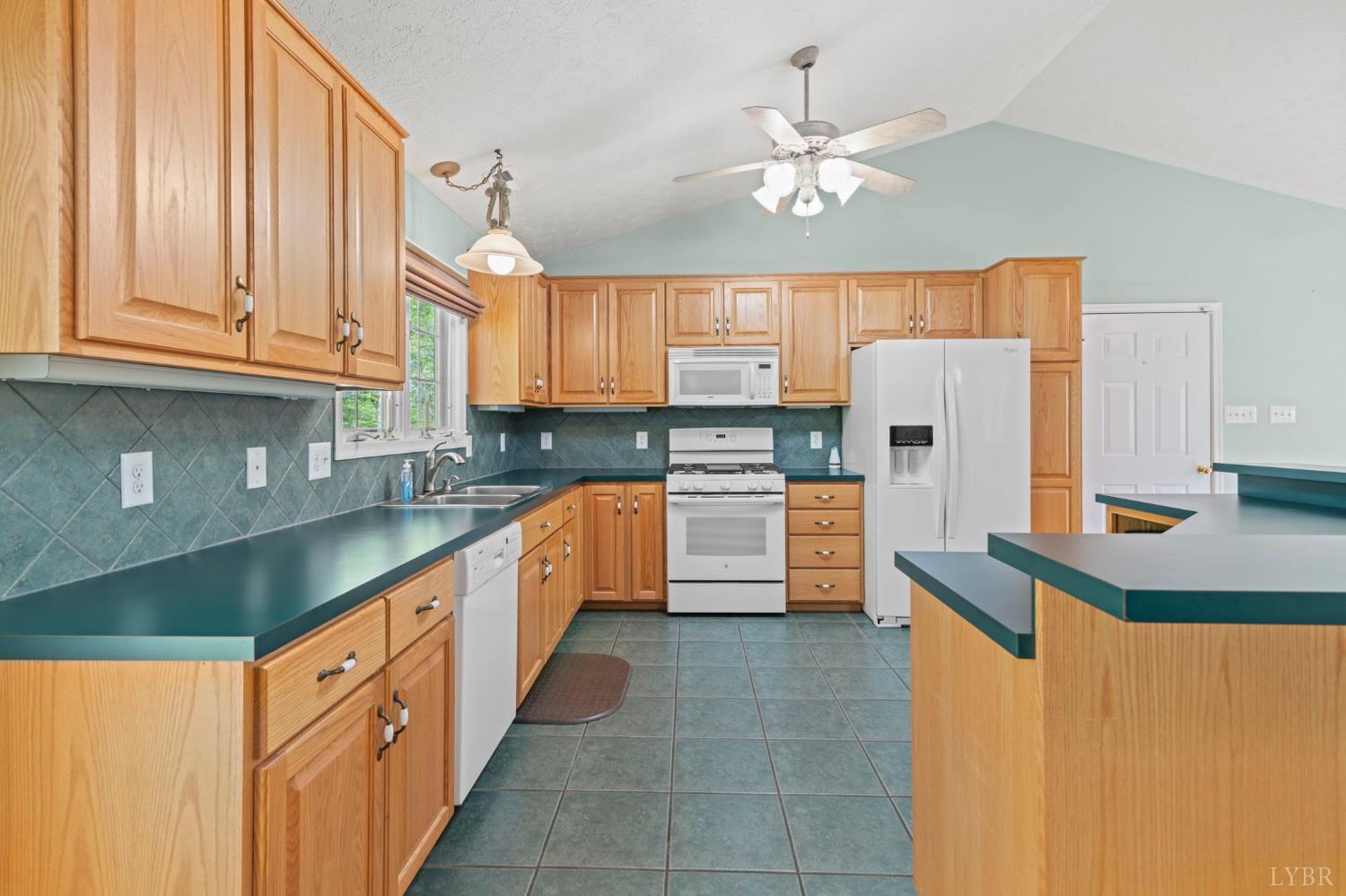 298 Braxton Ridge Road Amherst, VA 24521 - Photo 9 of 65 a kitchen with refrigerator and cabinets