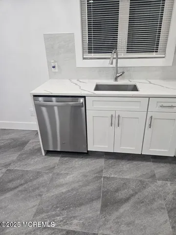 a kitchen with a sink and cabinets