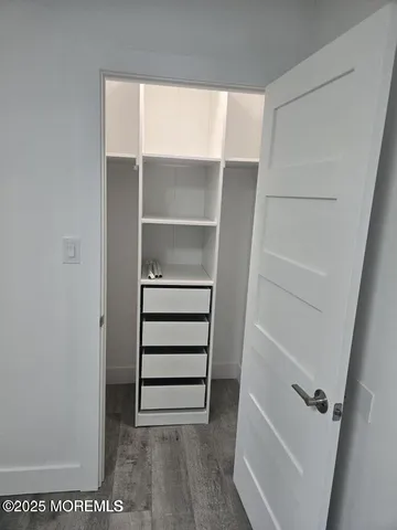 a view of walk in closet with empty racks
