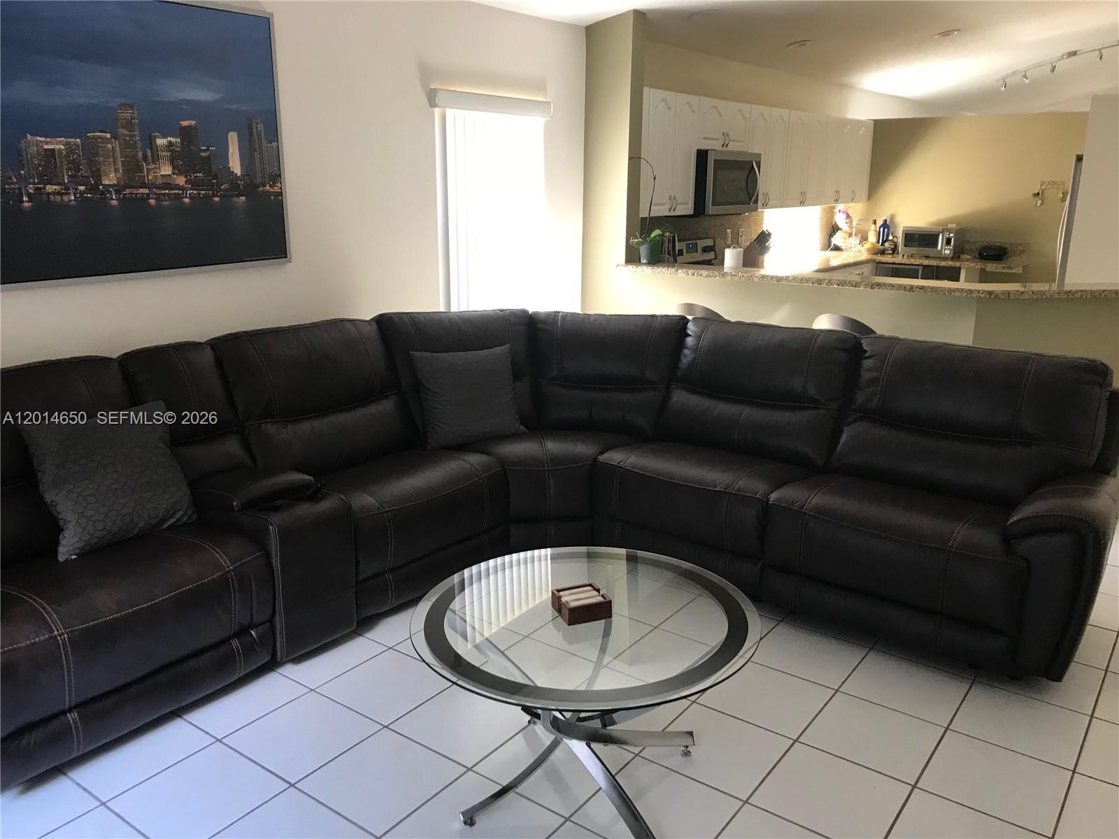 16654 Southwest 103rd Lane Miami, FL 33196 - Photo 7 of 20 a living room with furniture and a dining table with kitchen view
