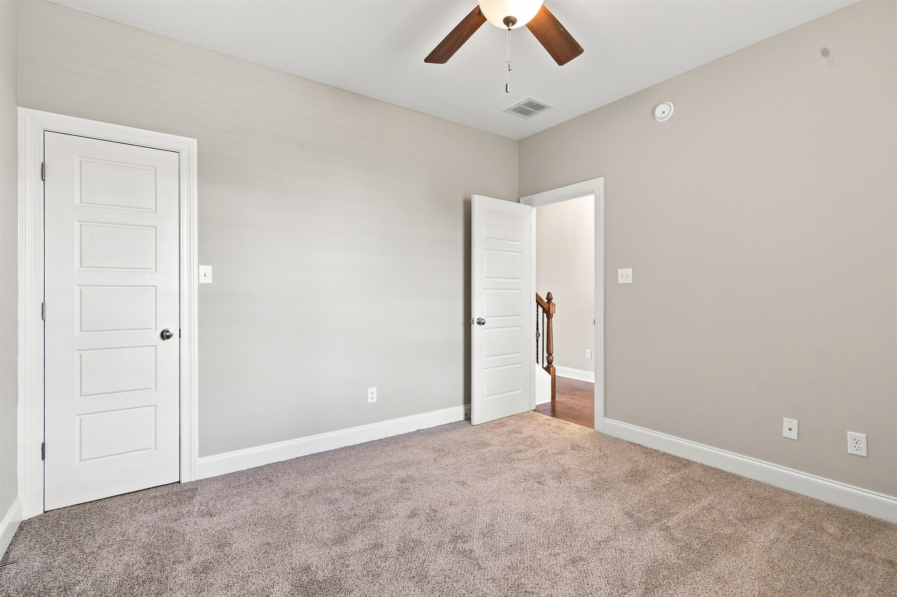 70 Trinity Cove Atoka, TN 38004 - Photo 12 of 19 Carpeted room with light neutral walls, white trim, and a ceiling fan