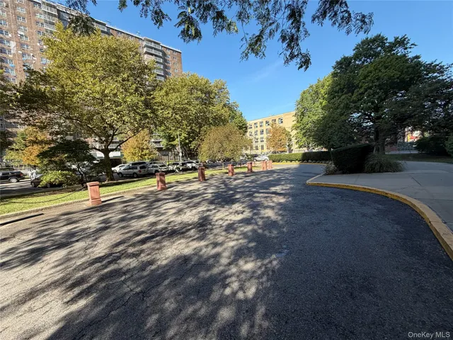 a view of a street with trees and houses