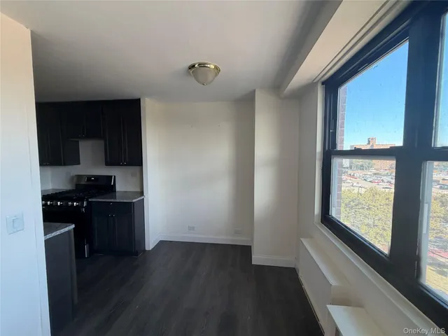 a kitchen with granite countertop a stove top oven a sink and a window