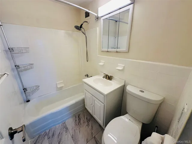 a white toilet sitting next to a bathroom sink