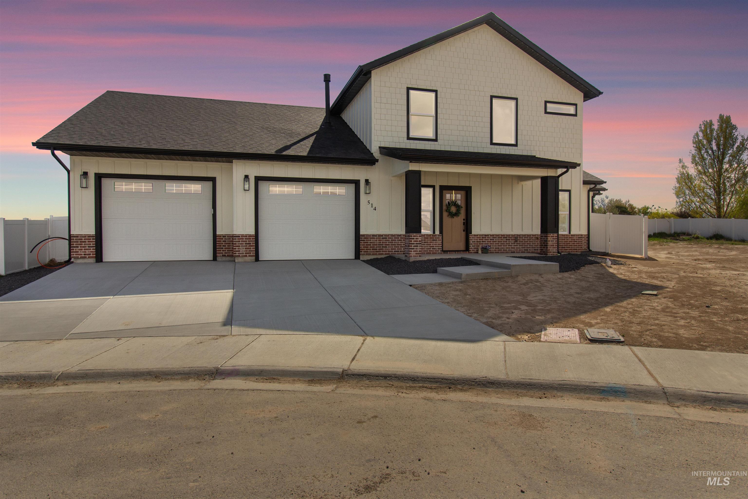 View of front facade with board and batten siding, a garage, a porch, driveway, and roof with shingles