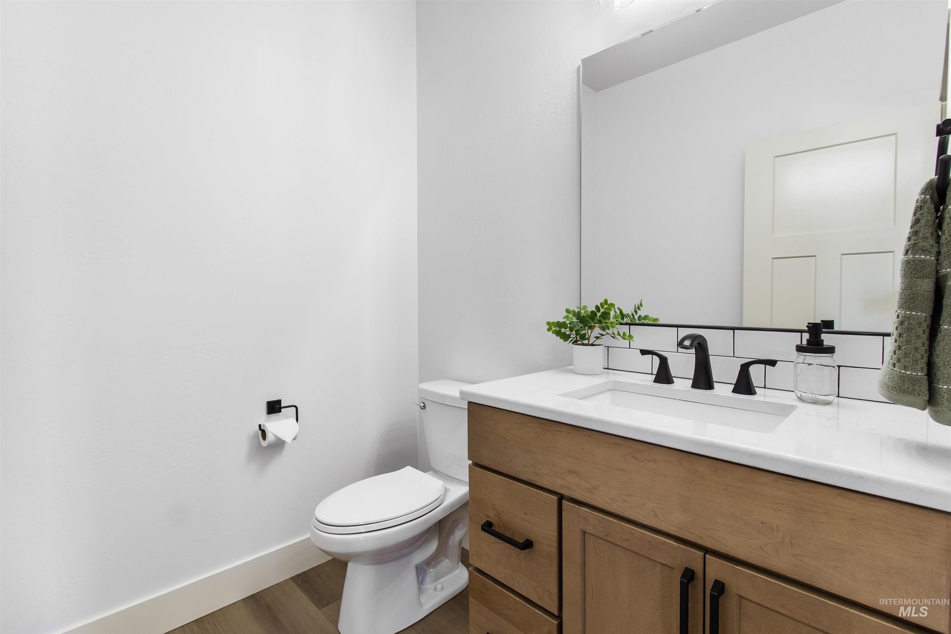 514 Full Moon Way Twin Falls, ID 83301 - Photo 16 of 49 Half bath with vanity and wood finished floors