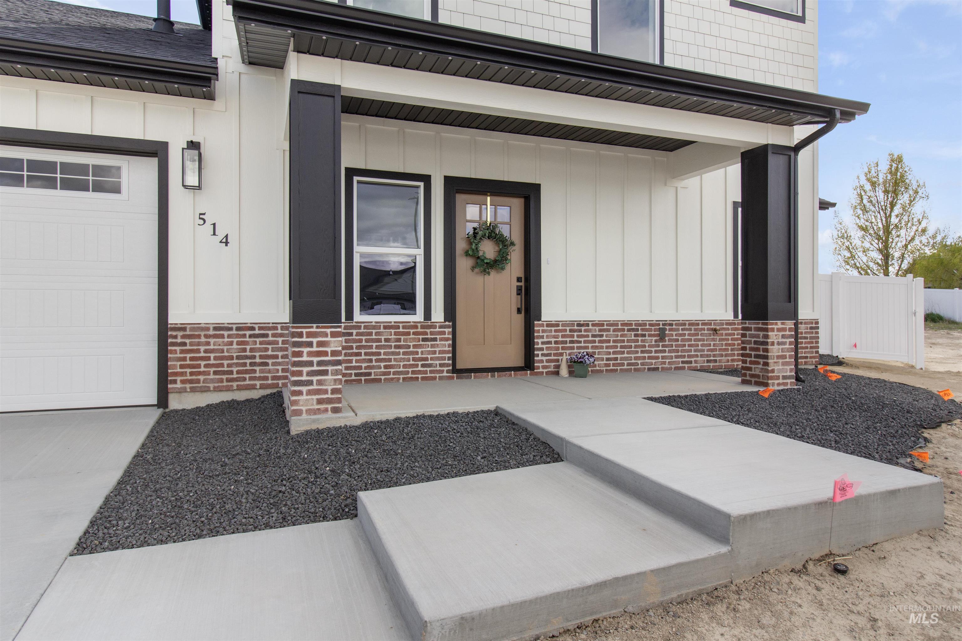 514 Full Moon Way Twin Falls, ID 83301 - Photo 2 of 49 Entrance to property featuring a porch, board and batten siding, and brick siding