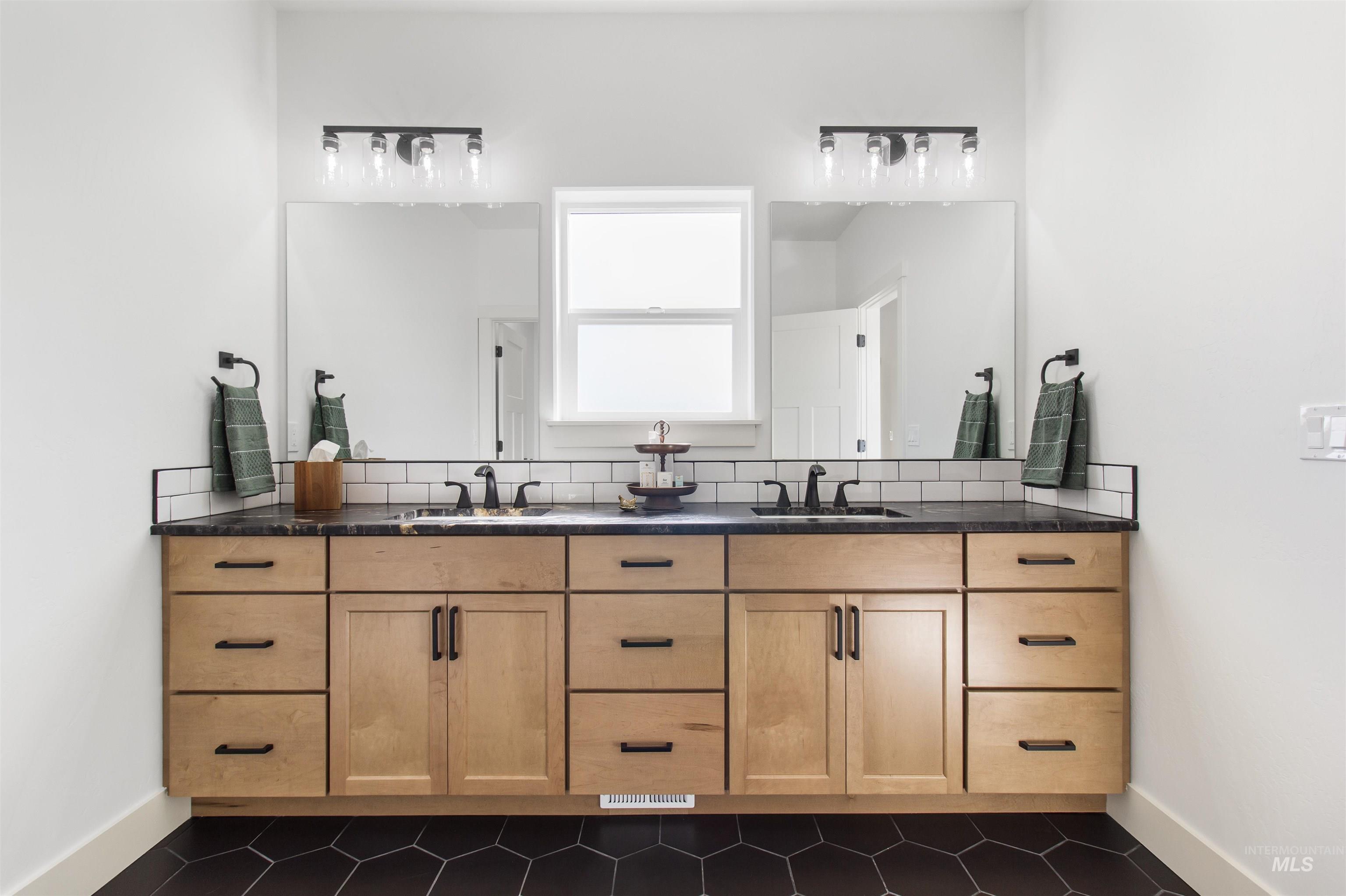 514 Full Moon Way Twin Falls, ID 83301 - Photo 22 of 49 Bathroom featuring double vanity, dark tile patterned floors, and backsplash