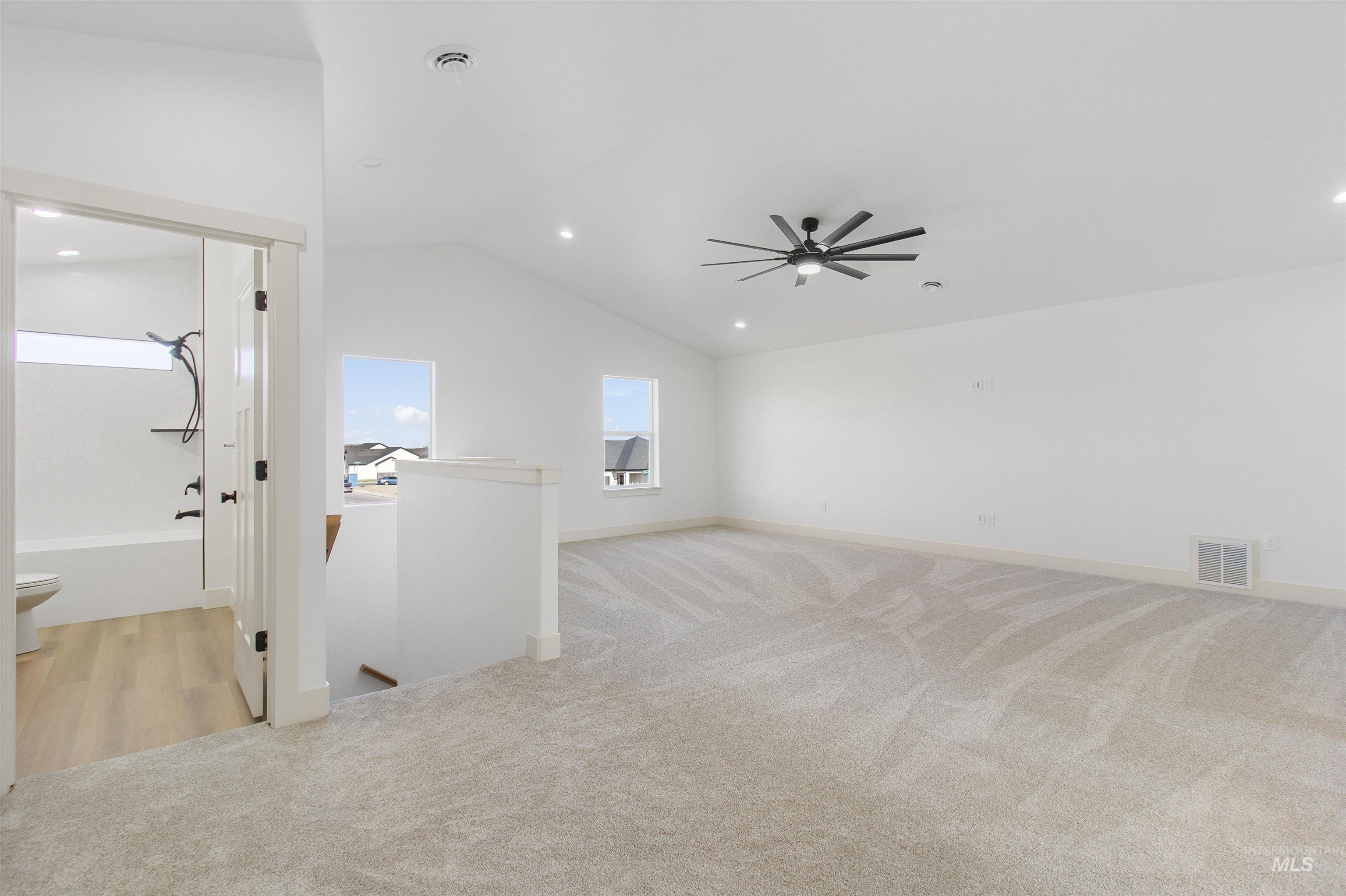 514 Full Moon Way Twin Falls, ID 83301 - Photo 29 of 49 Empty room featuring light carpet, lofted ceiling, a ceiling fan, and recessed lighting