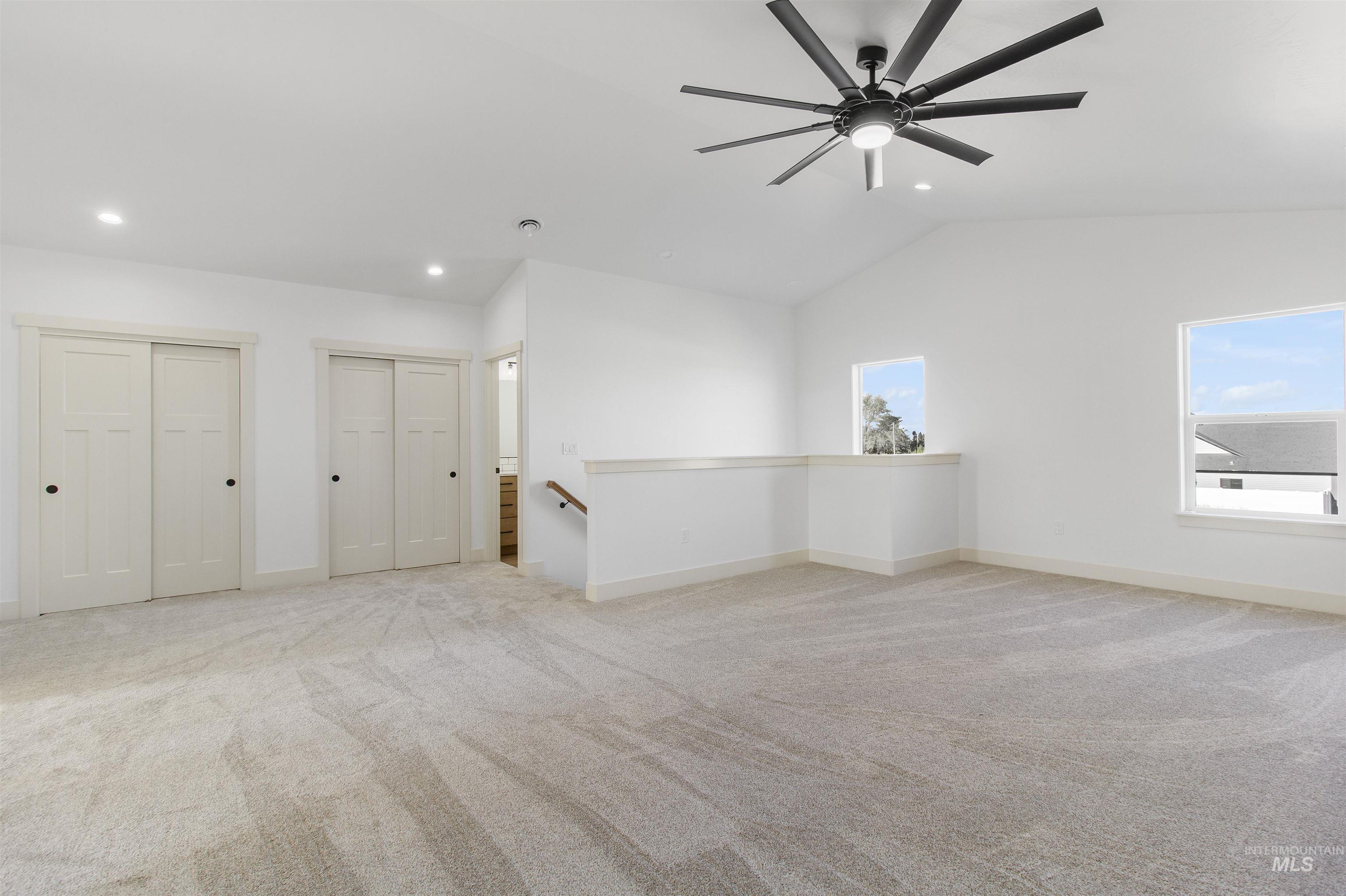 514 Full Moon Way Twin Falls, ID 83301 - Photo 31 of 49 Unfurnished room featuring light carpet, healthy amount of natural light, ceiling fan, lofted ceiling, and recessed lighting