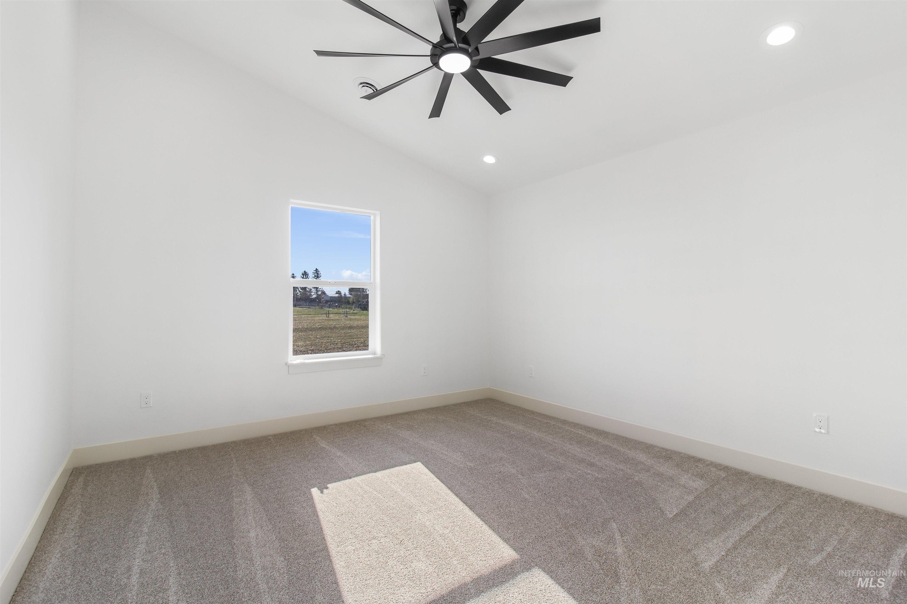 514 Full Moon Way Twin Falls, ID 83301 - Photo 32 of 49 Empty room with light colored carpet, vaulted ceiling, ceiling fan, and recessed lighting