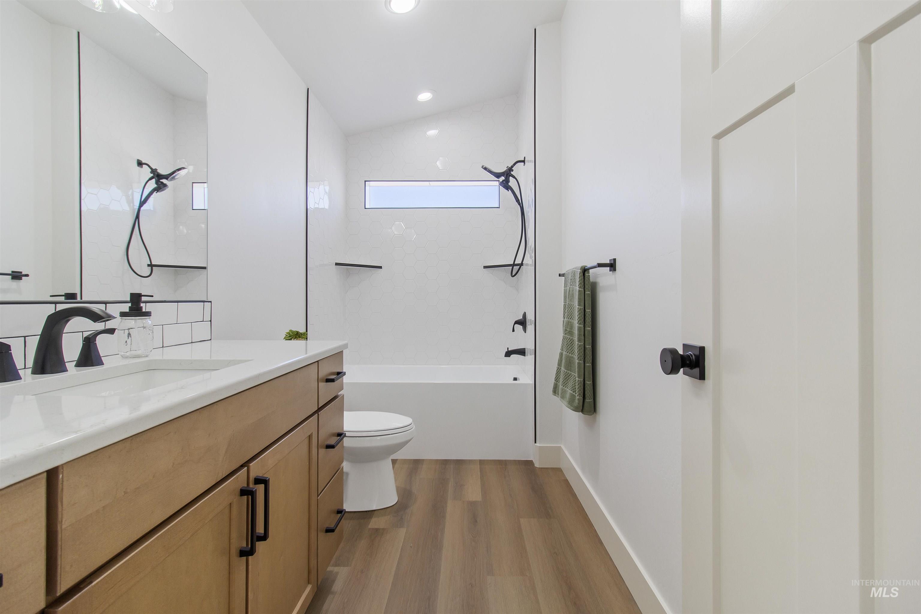 514 Full Moon Way Twin Falls, ID 83301 - Photo 35 of 49 Bathroom featuring vanity, light wood-style flooring, shower combination, and recessed lighting