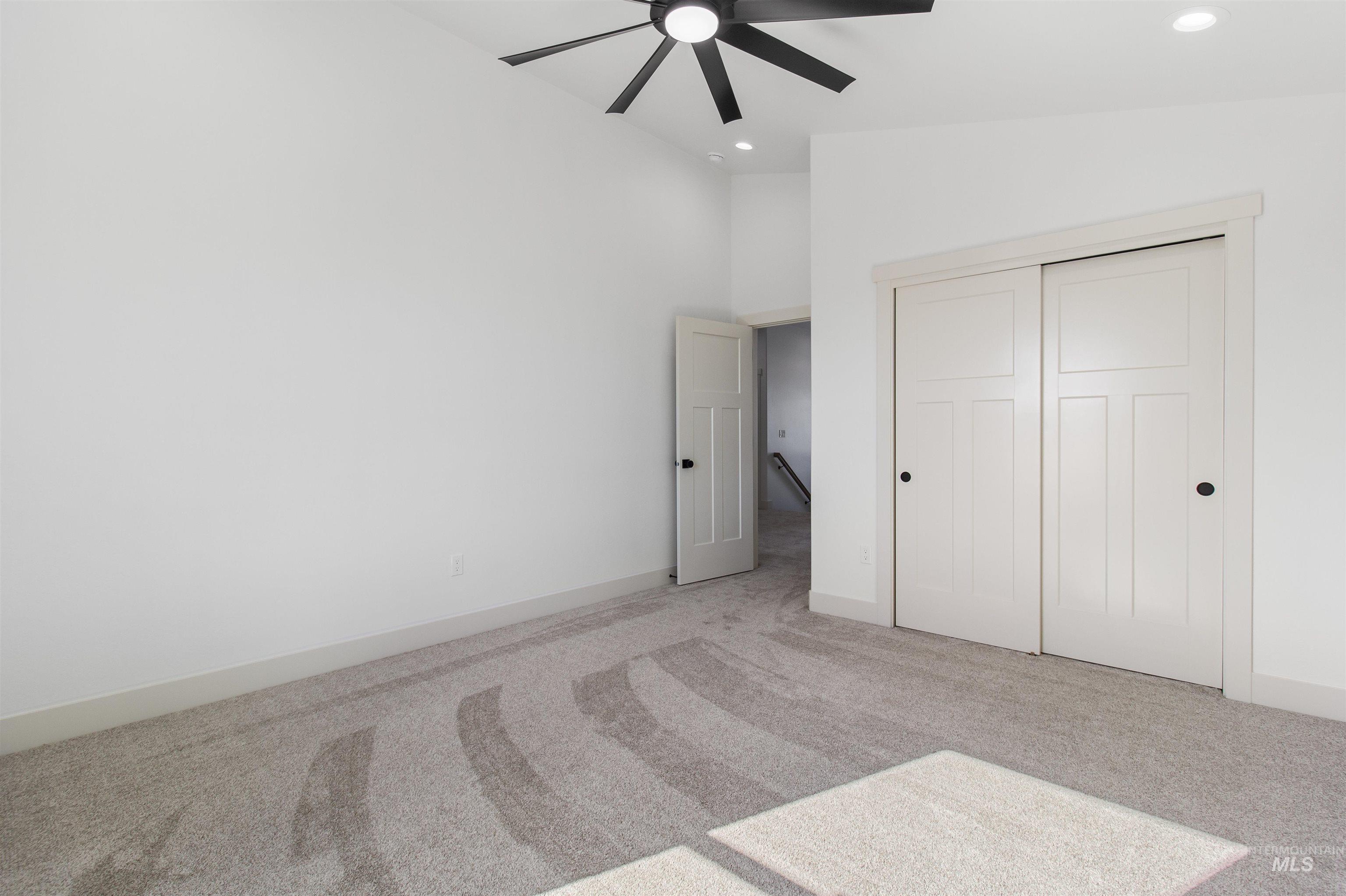 514 Full Moon Way Twin Falls, ID 83301 - Photo 37 of 49 Unfurnished bedroom with carpet, a closet, ceiling fan, recessed lighting, and a high ceiling