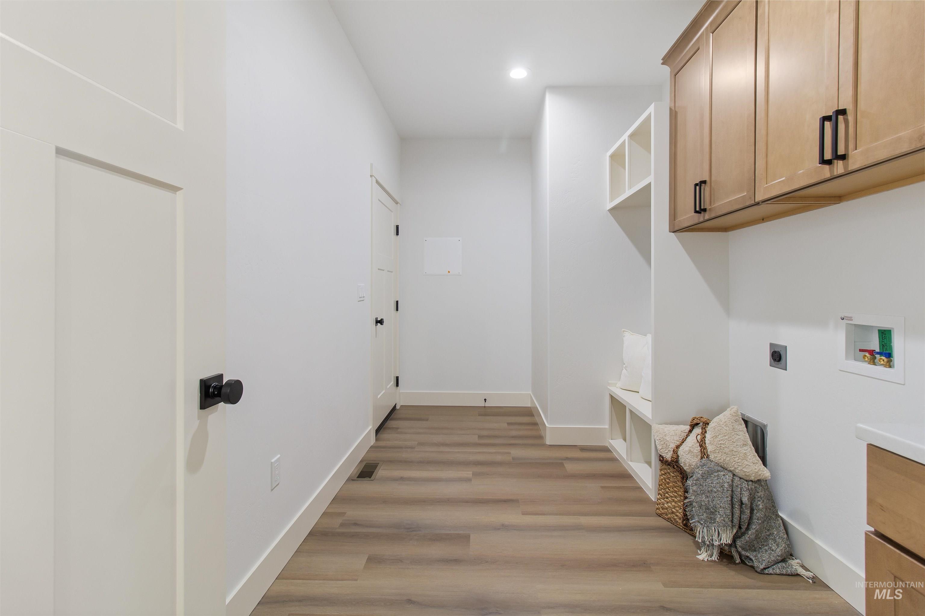 514 Full Moon Way Twin Falls, ID 83301 - Photo 39 of 49 Laundry area with light wood-type flooring, electric dryer hookup, cabinet space, hookup for a washing machine, and recessed lighting