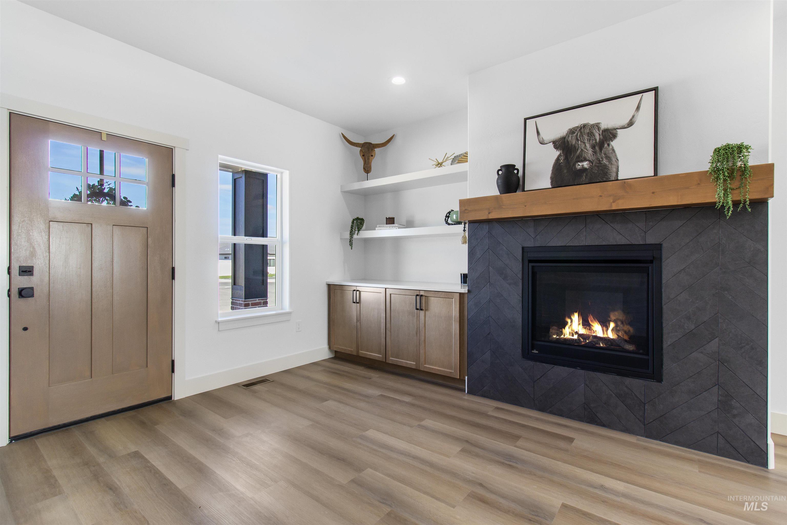 514 Full Moon Way Twin Falls, ID 83301 - Photo 5 of 49 Unfurnished living room with a glass covered fireplace, light wood-type flooring, and recessed lighting